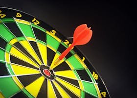 Close-up of a dart successfully hitting the bullseye on a bright dartboard, signifying victory.